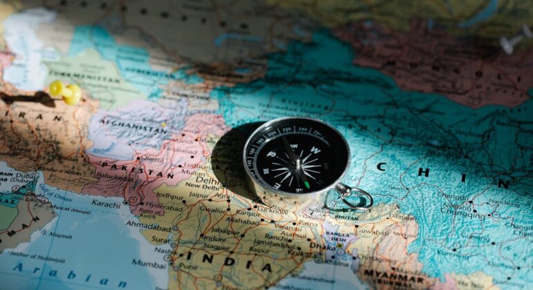 world map with a compass