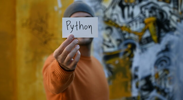 man with a paper Python written on