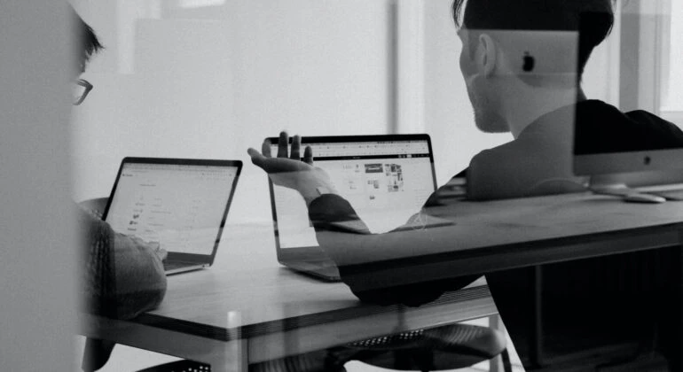 Python developers working with a computer