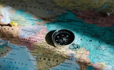 world map with a compass