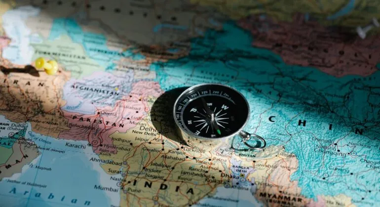 world map with a compass