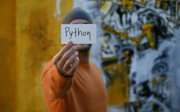 man with a paper Python written on