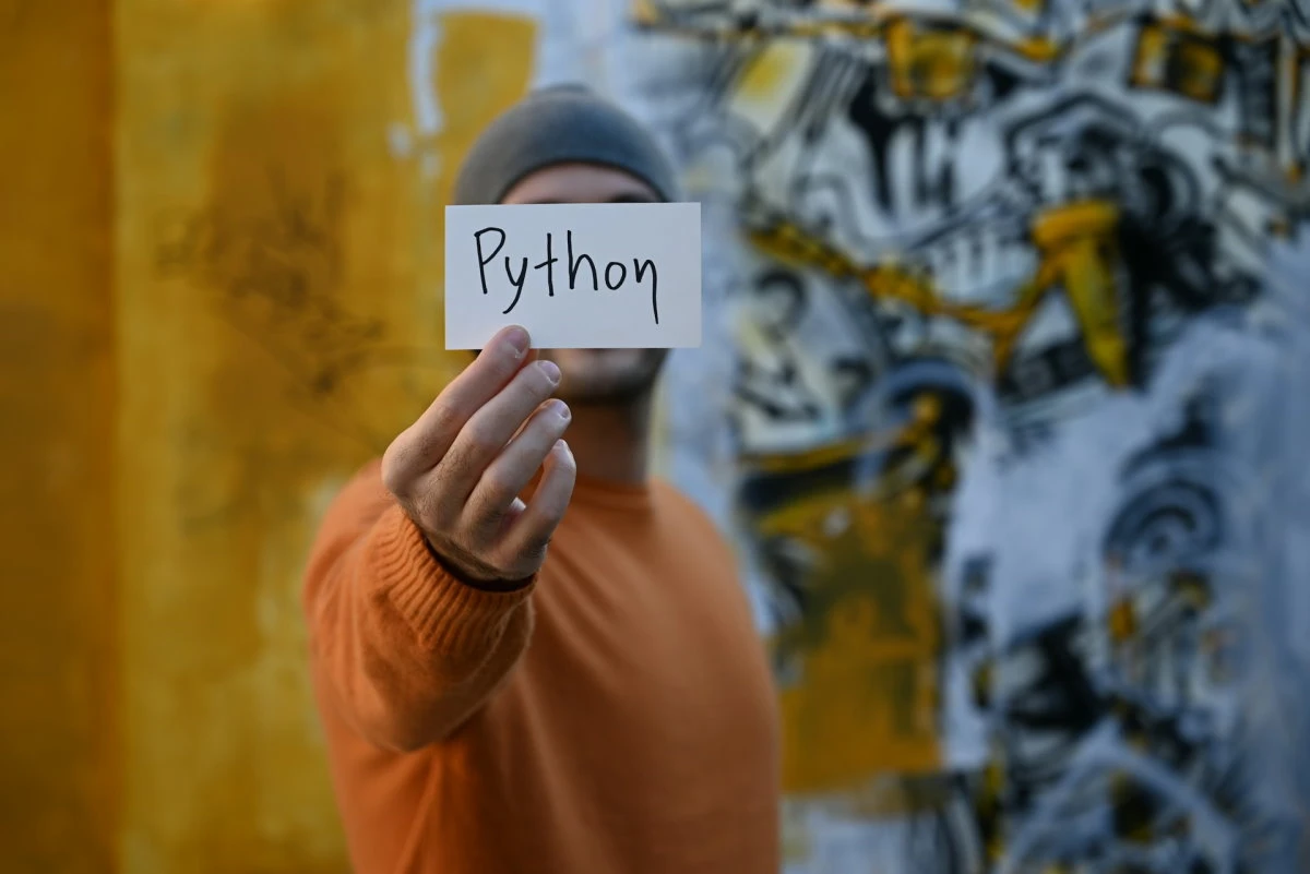man with a paper Python written on
