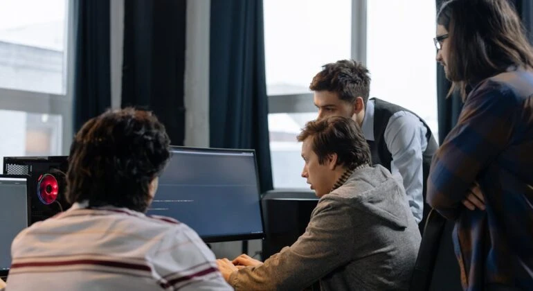 software developers around a single computer